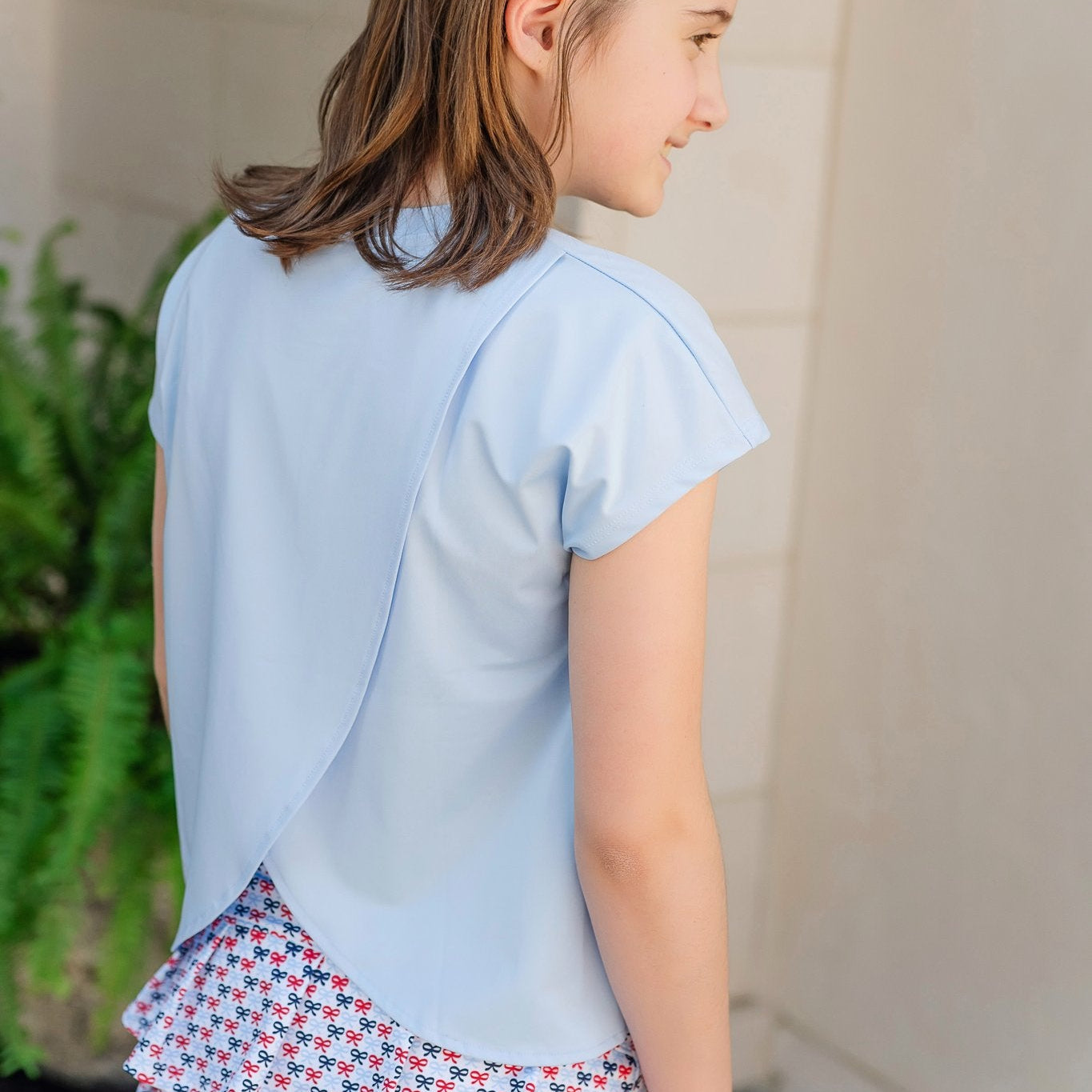 Sloane Girls' Short Sleeve Performance Top by LH Sport - Light Blue